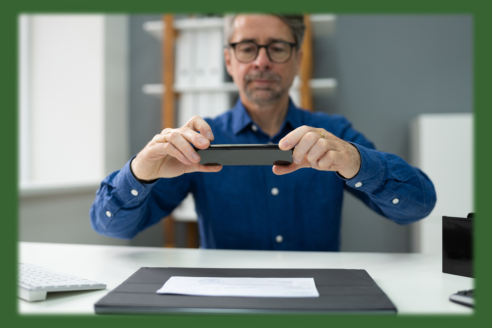 man taking a picture of a check with his cellphone